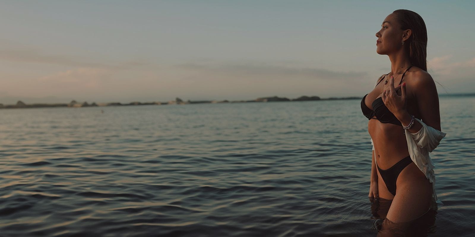 Woman in black swimwear standing in water