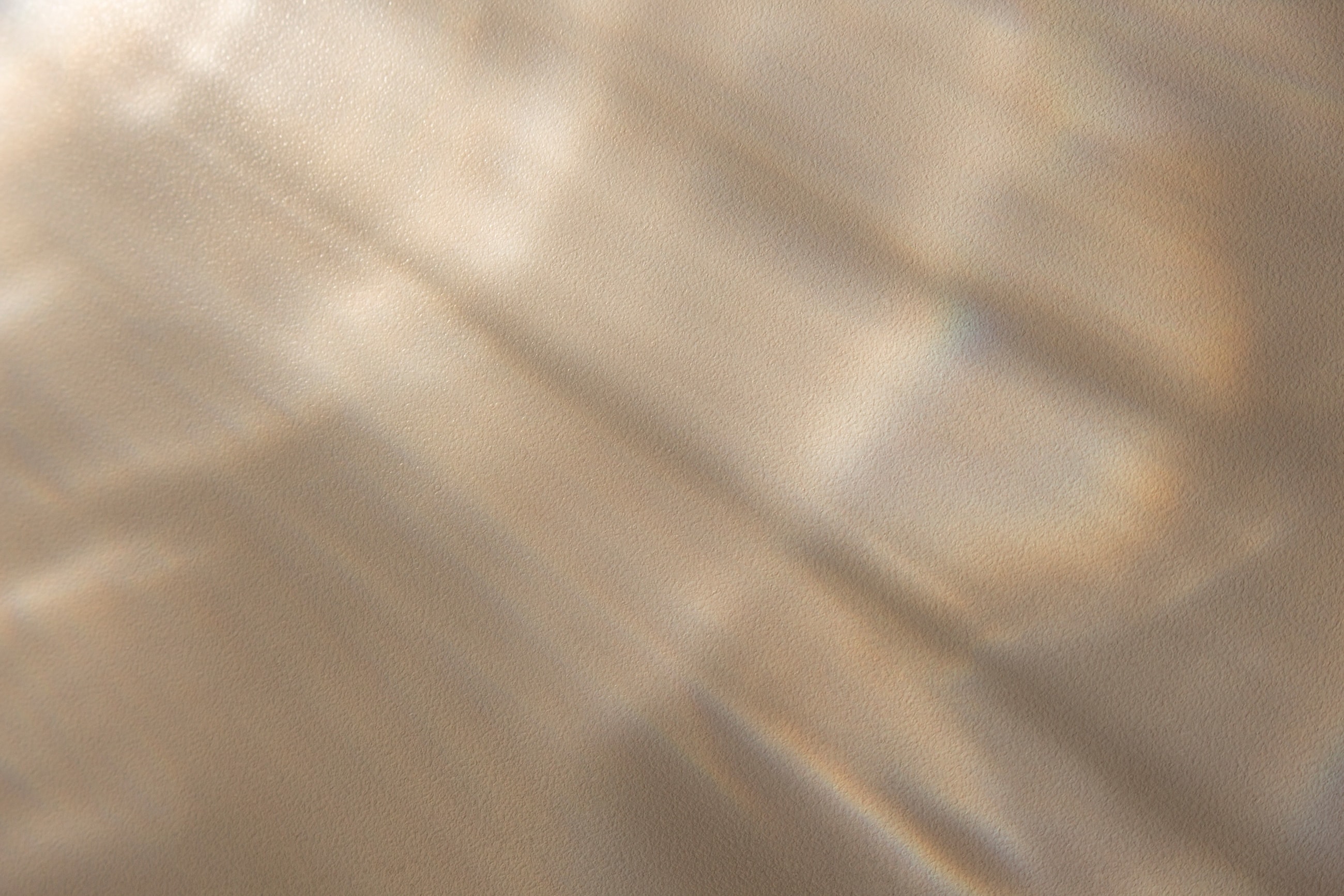 Textured gold and bronze metallic surface background.