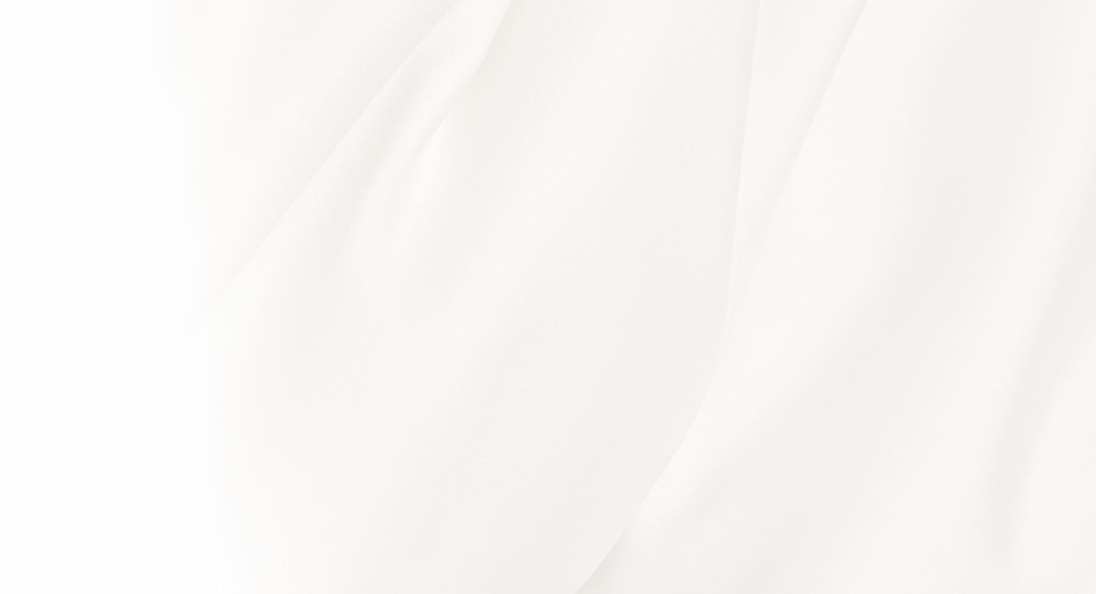 Soft white fabric with gentle folds and texture.