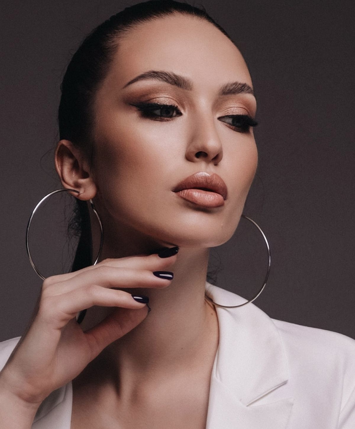 Dr. Gopathi administering beauty treatment to patient.