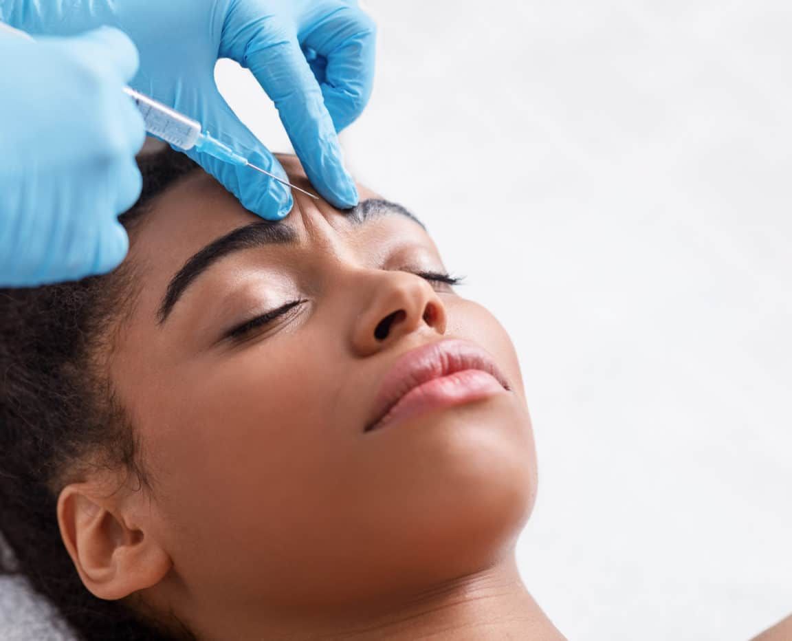 Plastic,Surgery.,Young,African,Woman,Receiving,Botox,Injection,In,Interbrow